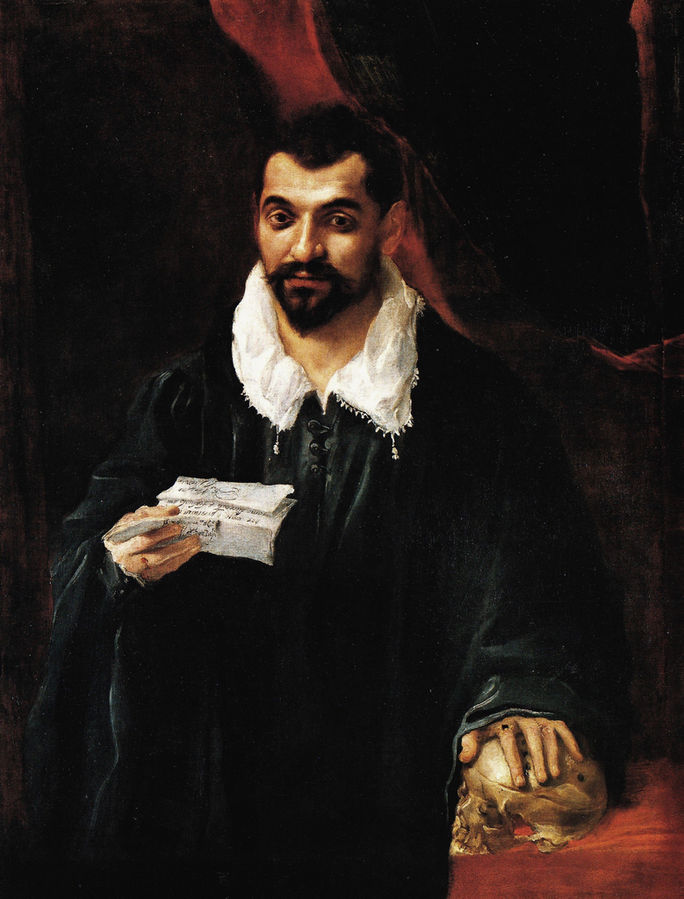 Portrait of a man holding a skull 